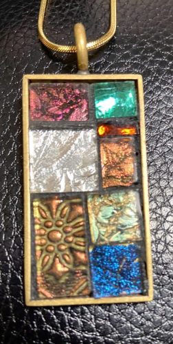 a colorful mosaic jewelry pendant